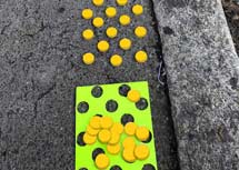 Tactile paving discs as road signs for blind people